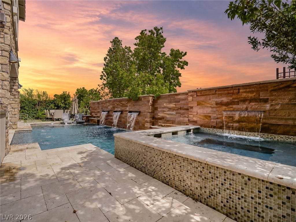 12013 Tramonto Avenue, Las Vegas, NV 89138 A sparkling swimming pool and elevated spa are framed by elegant stone accent walls.