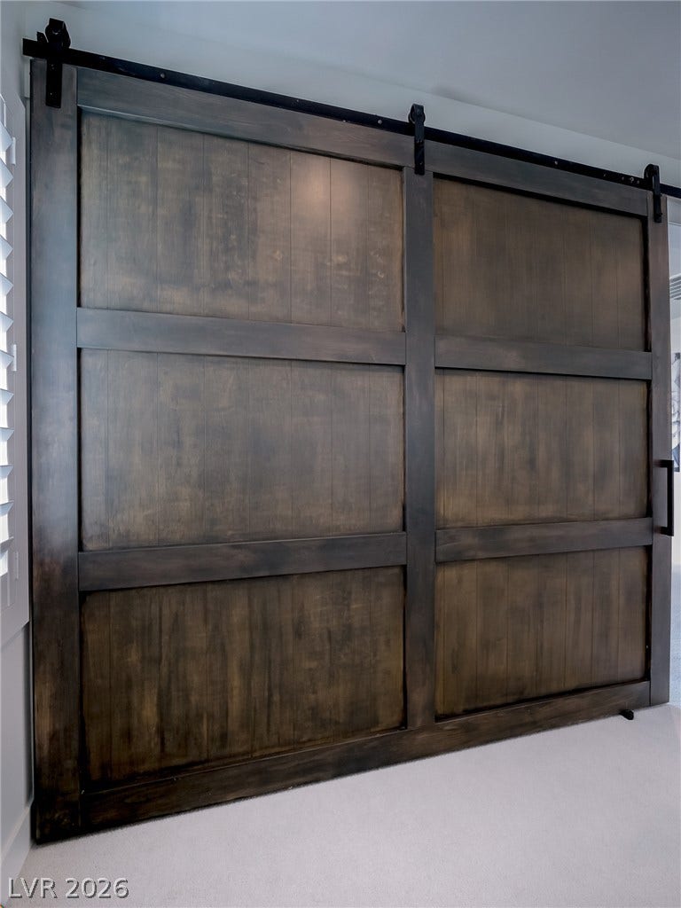 12013 Tramonto Avenue, Las Vegas, NV 89138 Massive sliding barn doors add a rustic touch and separate interior spaces beautifully.