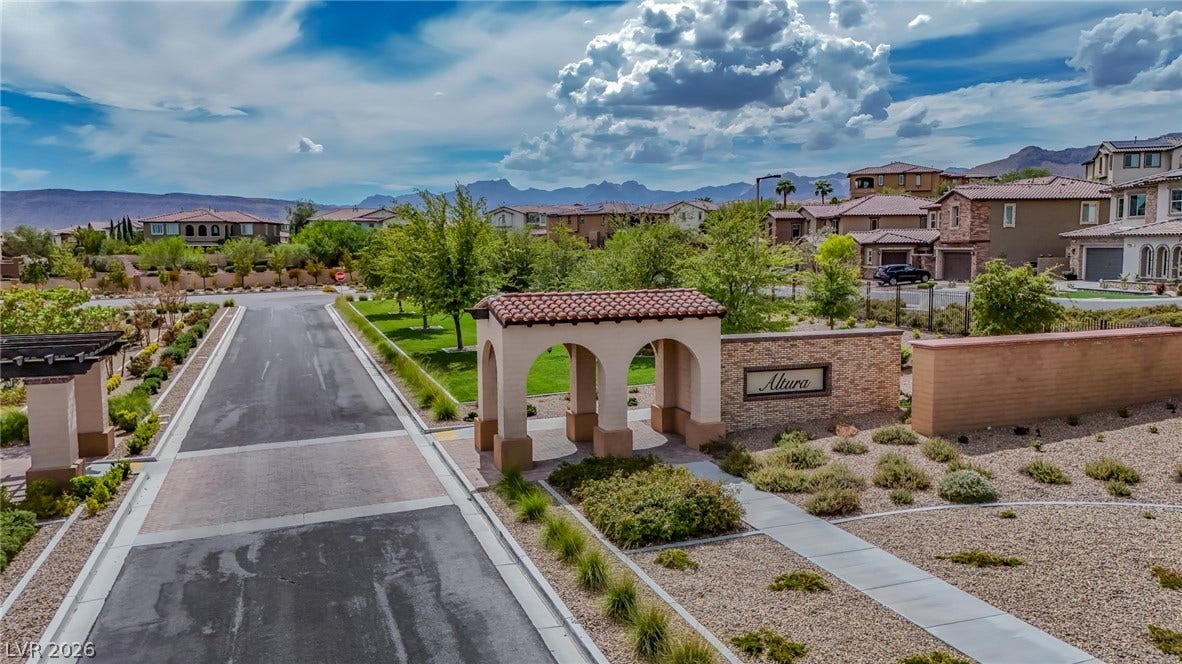 12013 Tramonto Avenue, Las Vegas, NV 89138 An arched entry monument and a paved roadway lead into this peaceful suburban neighborhood.