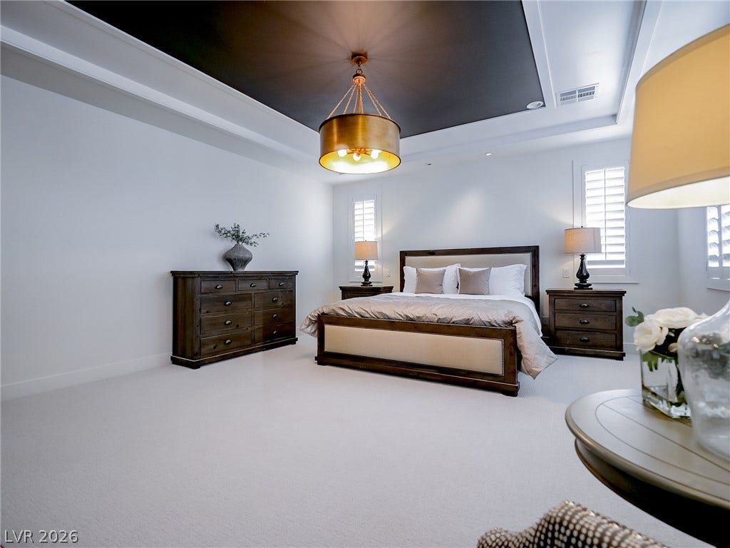 12013 Tramonto Avenue, Las Vegas, NV 89138 An elegant tray ceiling with a dark inset anchors this masterfully designed bedroom retreat.