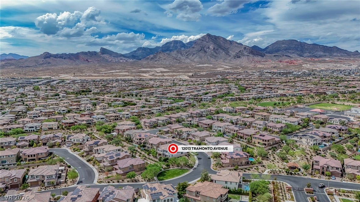 12013 Tramonto Avenue, Las Vegas, NV 89138 Dramatic mountain ranges frame this peaceful desert community from a high-altitude perspective.