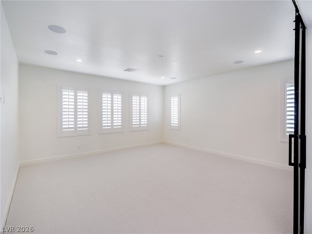 12013 Tramonto Avenue, Las Vegas, NV 89138 Crisp white walls and plush carpeting define this versatile, light-filled interior space.