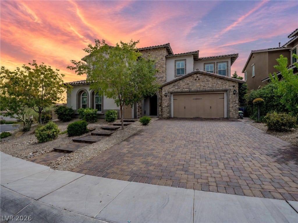 12013 Tramonto Avenue, Las Vegas, NV 89138 A stone-accented facade and paver driveway set a grand tone for this multi-level residence.