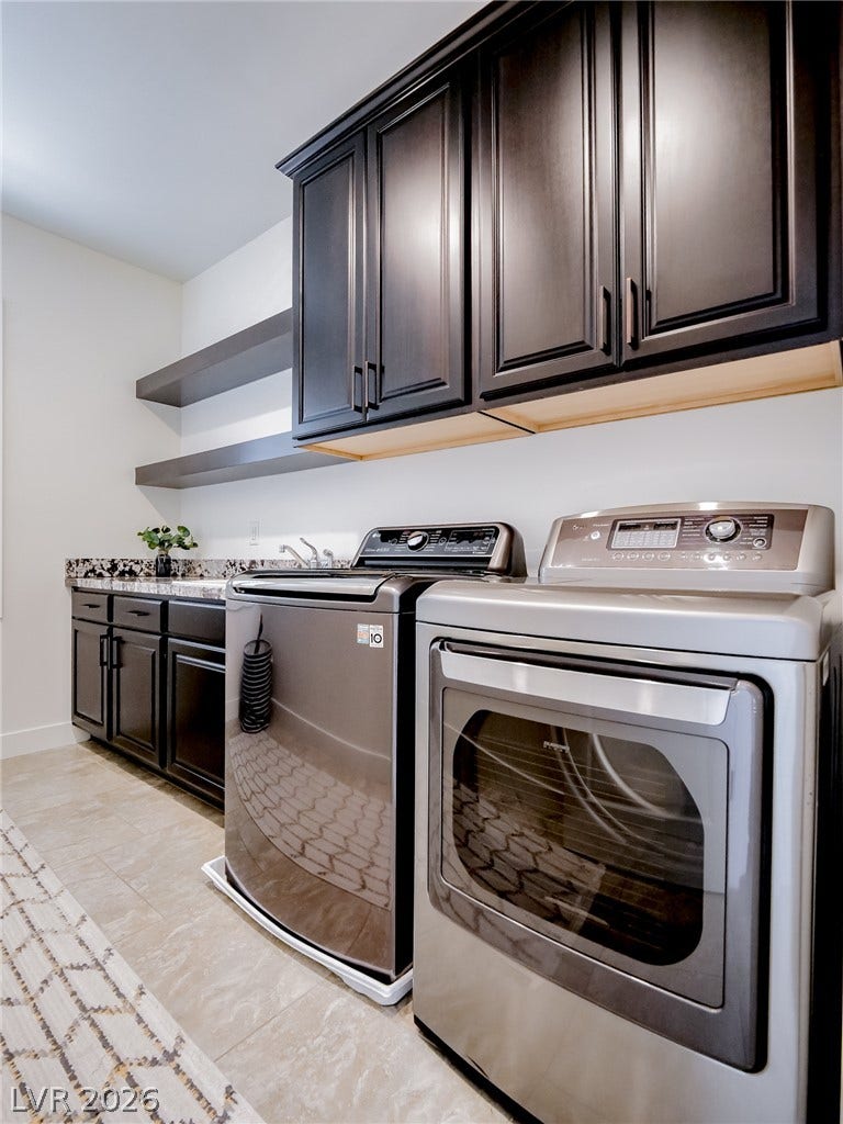 12013 Tramonto Avenue, Las Vegas, NV 89138 Dark cabinetry and matching open shelving elevate this functional workspace.