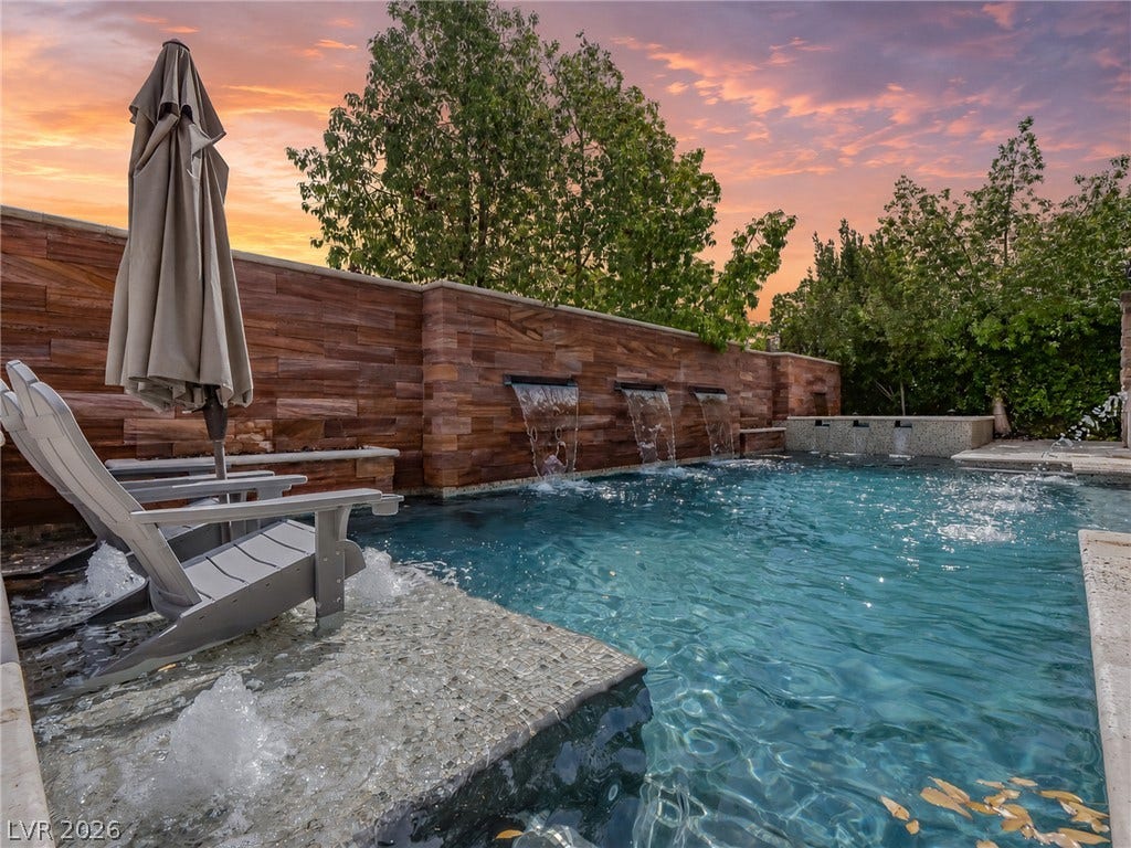 12013 Tramonto Avenue, Las Vegas, NV 89138 Glistening waters and stone-clad privacy walls create a serene backyard oasis.