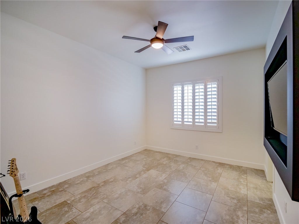 12013 Tramonto Avenue, Las Vegas, NV 89138 Gleaming tile floors and clean modern walls define this versatile bonus room.