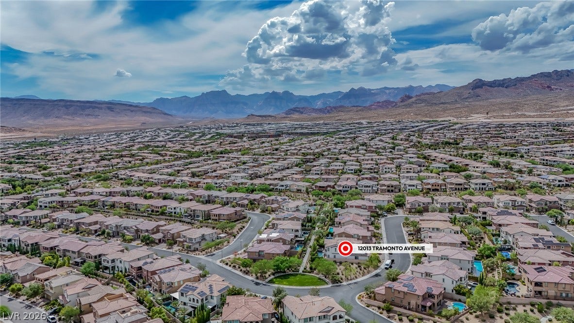 12013 Tramonto Avenue, Las Vegas, NV 89138 Dramatic mountain ranges frame a sprawling neighborhood of beautiful tile-roofed residences.