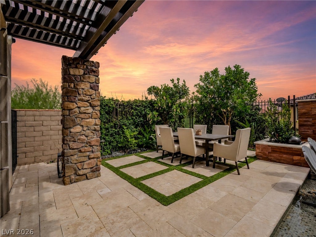 12013 Tramonto Avenue, Las Vegas, NV 89138 Sunset views frame this elegant stone-accented outdoor terrace paved with sleek limestone tiles.