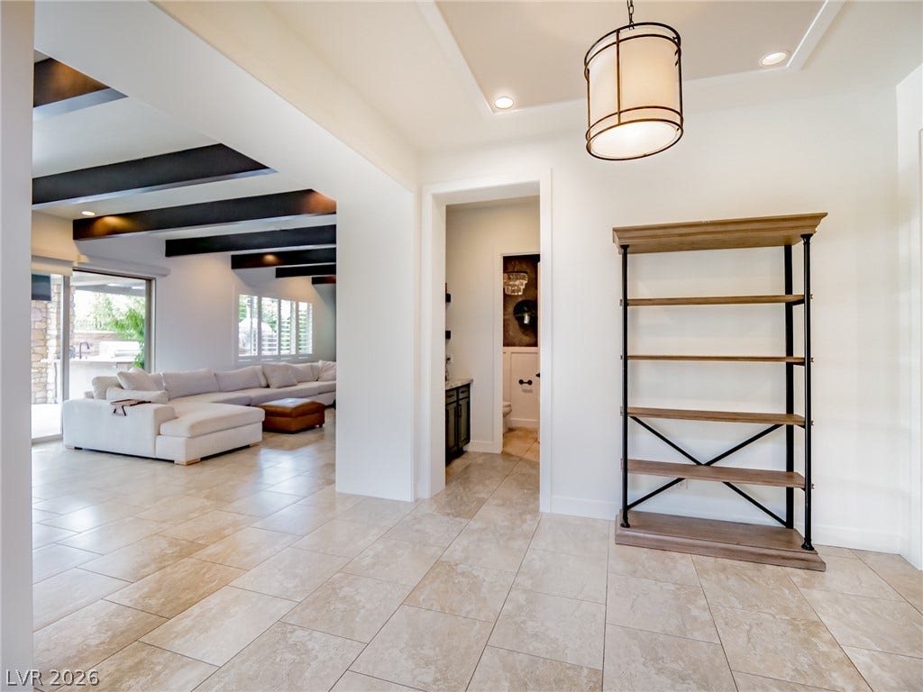 12013 Tramonto Avenue, Las Vegas, NV 89138 Stone tile floors and architectural beam ceilings create an open, connected living experience.