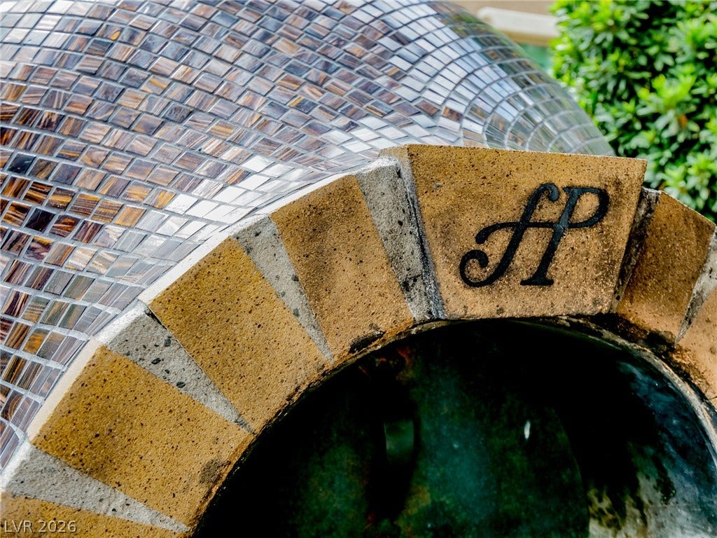 12013 Tramonto Avenue, Las Vegas, NV 89138 An outdoor pizza oven features intricate tile detailing and custom stonework.