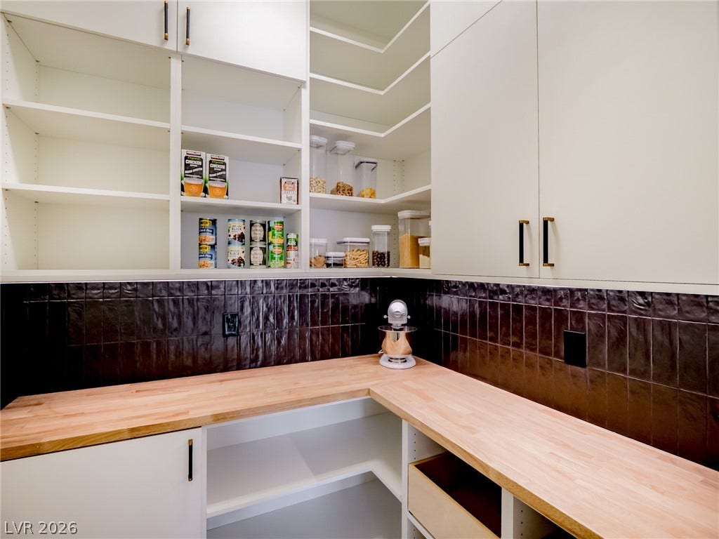 12013 Tramonto Avenue, Las Vegas, NV 89138 An organized walk-in pantry provides extensive custom shelving and smooth butcher block countertops.