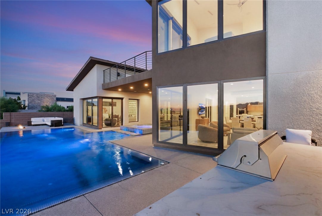 2208 Overlook Canyon Lane, Henderson, NV 89052 Luminous pool and inviting outdoor living spaces frame a modern desert retreat at twilight.