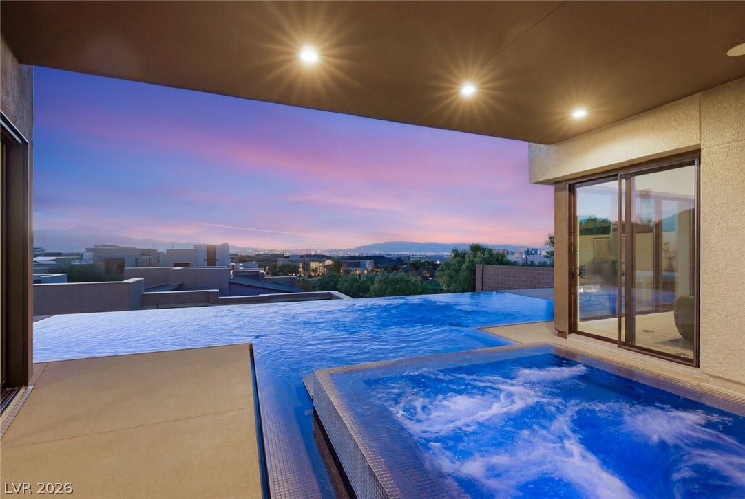 2208 Overlook Canyon Lane, Henderson, NV 89052 An inviting infinity-edge pool and spa complement breathtaking views under a colorful twilight sky.