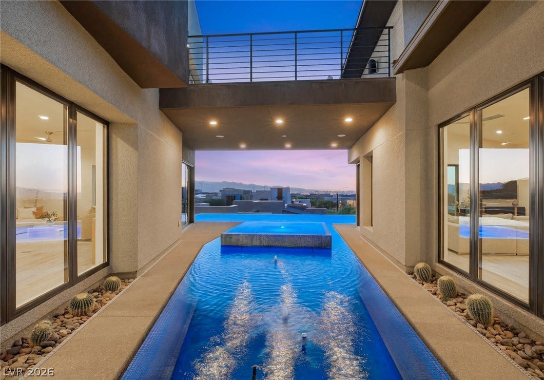 2208 Overlook Canyon Lane, Henderson, NV 89052 An inviting water feature and infinity pool lead to an impressive city and mountain panorama.