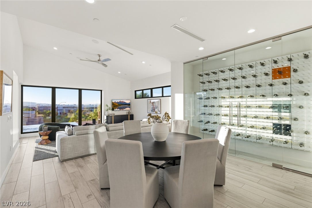 2208 Overlook Canyon Lane, Henderson, NV 89052 Vast window walls and vaulted ceilings illuminate a refined living area with an adjacent, custom-designed wine cellar.