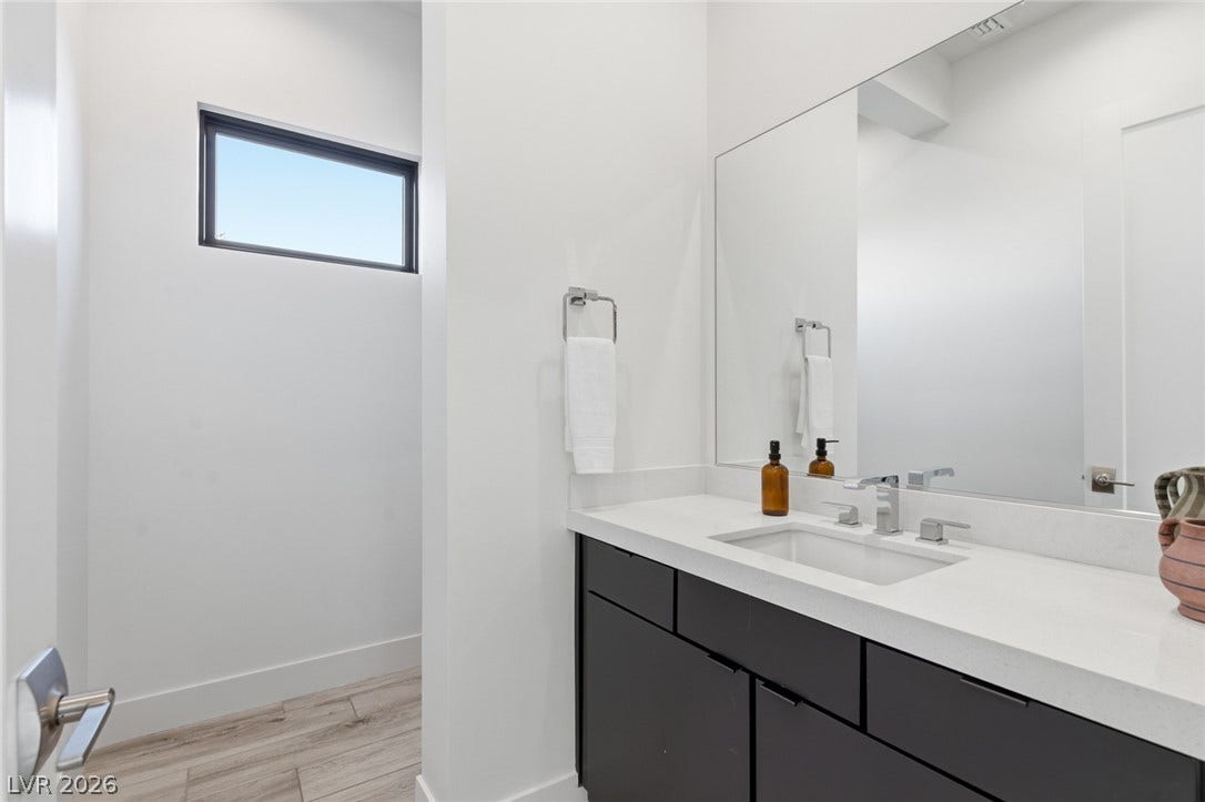 2208 Overlook Canyon Lane, Henderson, NV 89052 A well-lit powder room offers contemporary style with a sleek vanity and a private window.