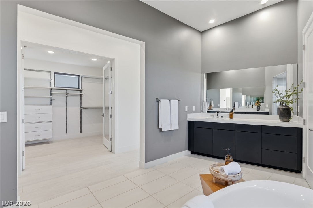 2208 Overlook Canyon Lane, Henderson, NV 89052 A well-appointed primary bathroom featuring a spacious vanity with dual sinks and a large walk-in closet.