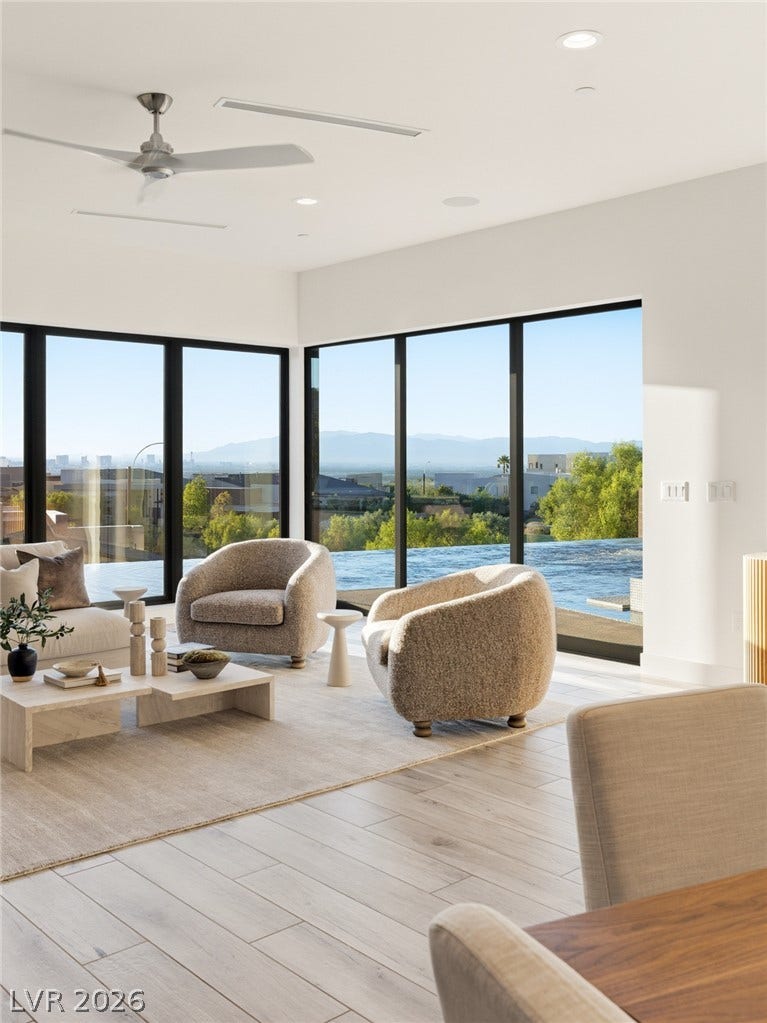 2208 Overlook Canyon Lane, Henderson, NV 89052 Floor-to-ceiling windows frame a panoramic vista in this elegant living area.