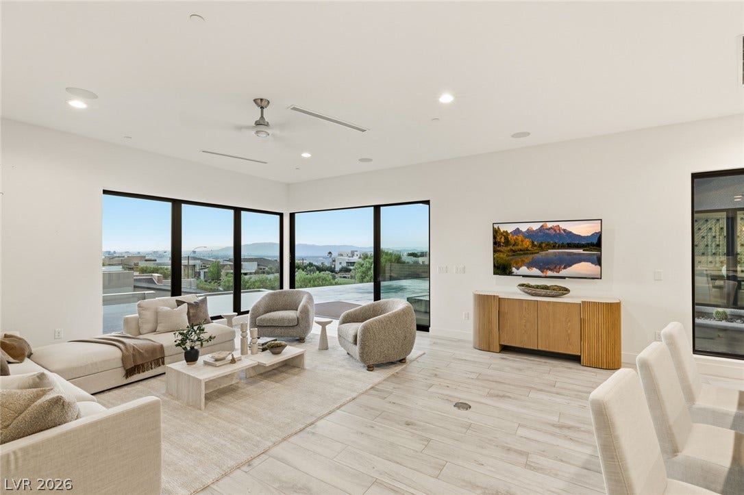 2208 Overlook Canyon Lane, Henderson, NV 89052 Floor-to-ceiling windows frame sweeping landscape views in this spacious gathering area.