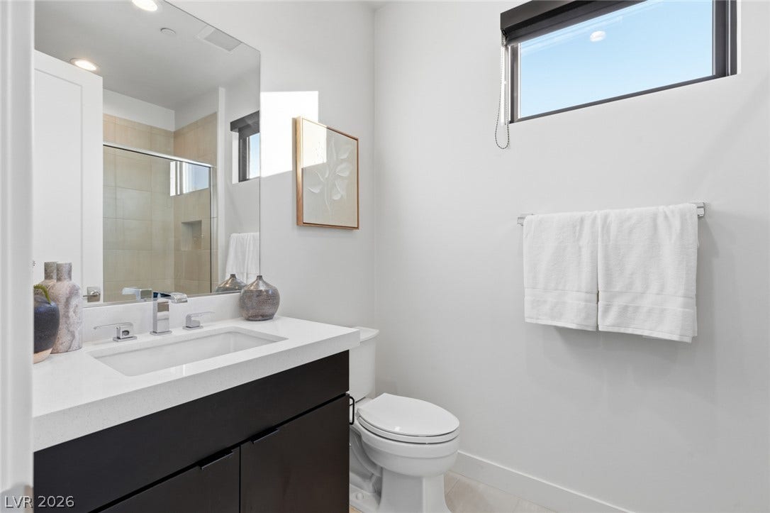 2208 Overlook Canyon Lane, Henderson, NV 89052 A well-appointed bathroom with clean lines, featuring a sleek vanity and modern fixtures.