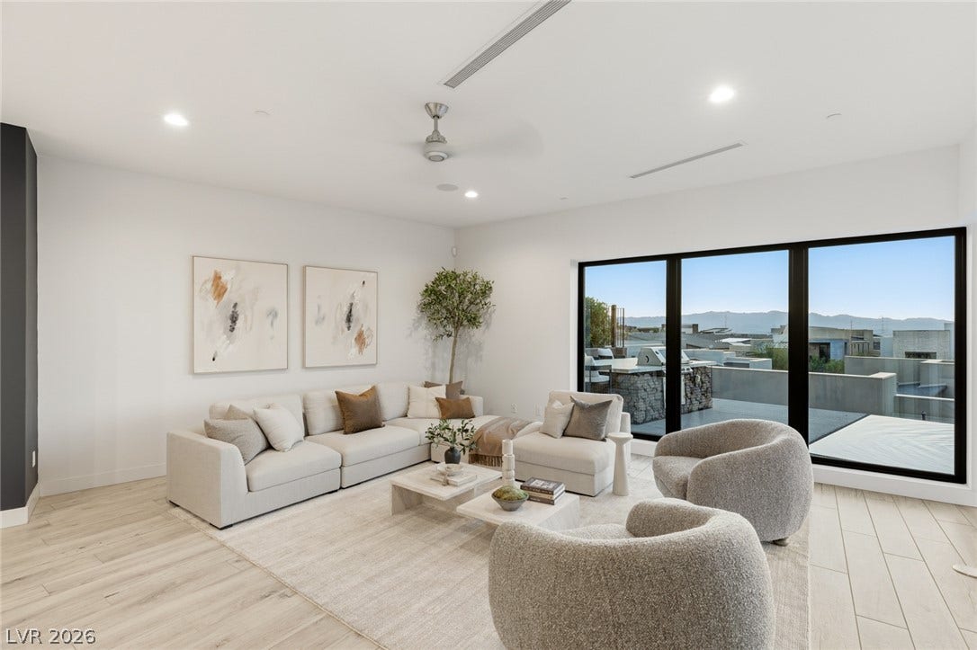 2208 Overlook Canyon Lane, Henderson, NV 89052 Floor-to-ceiling windows offer captivating distant mountain views in this contemporary living area.