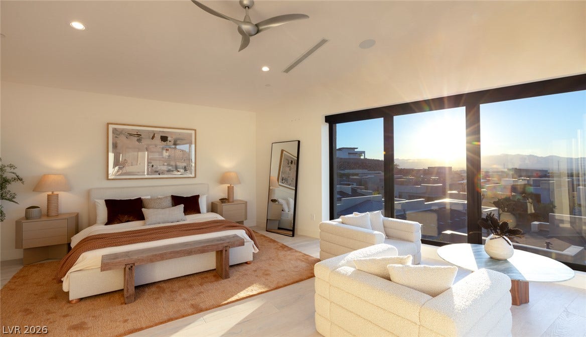 2208 Overlook Canyon Lane, Henderson, NV 89052 Natural light floods this primary bedroom through expansive windows, framing distant mountains.