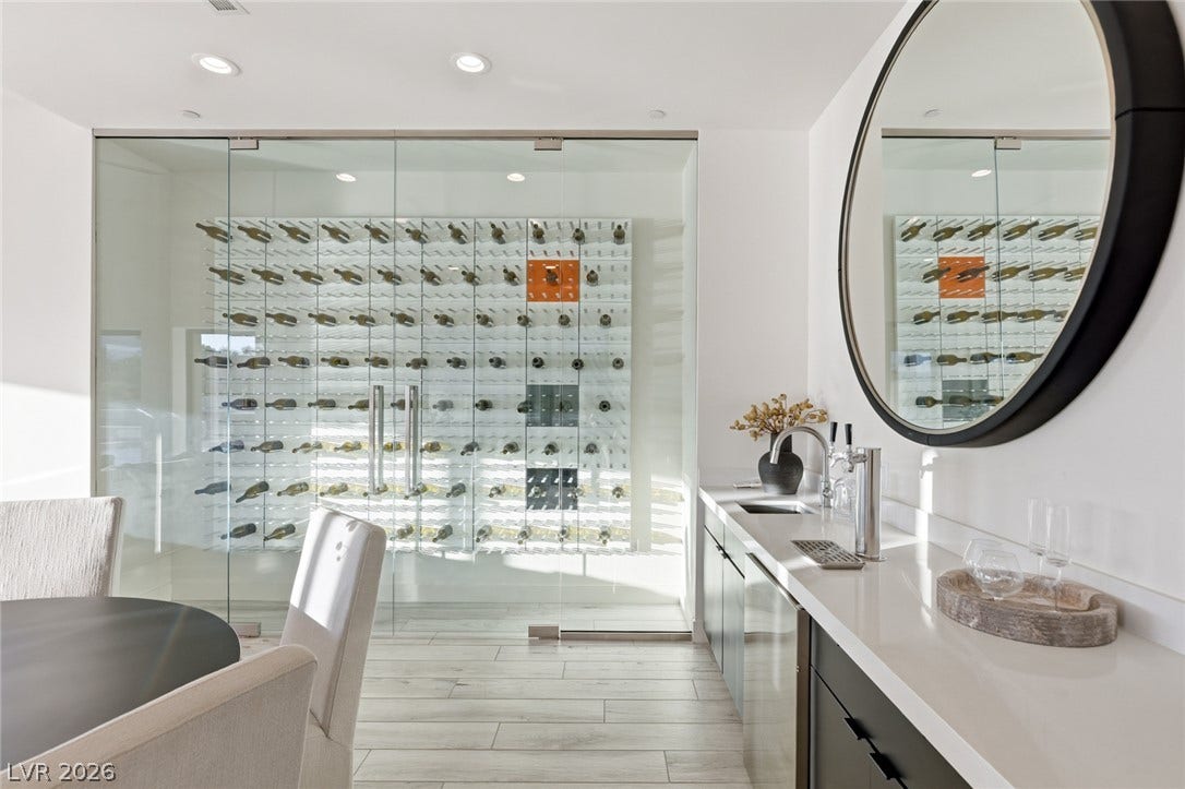 2208 Overlook Canyon Lane, Henderson, NV 89052 An impressive wine cellar, encased in glass, provides a refined focal point for entertaining.