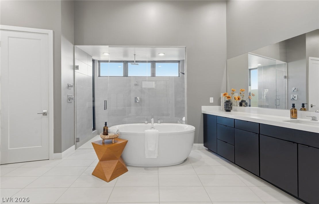2208 Overlook Canyon Lane, Henderson, NV 89052 Indulge in this tranquil primary bath, complete with a freestanding soaking tub and dual vanity.