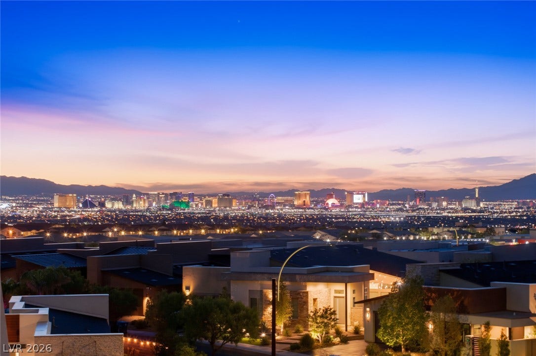 2208 Overlook Canyon Lane, Henderson, NV 89052 City lights illuminate the twilight horizon, offering captivating views from this residential setting.