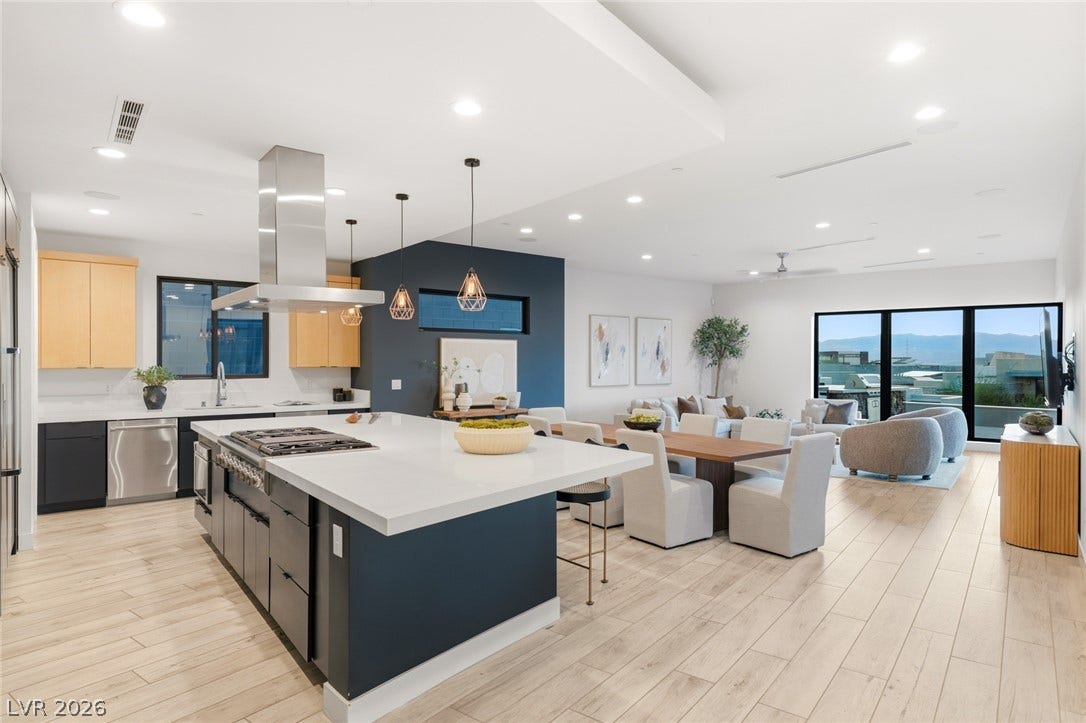 2208 Overlook Canyon Lane, Henderson, NV 89052 An open-concept living space integrates a chef's kitchen, dining area, and living room with panoramic views.