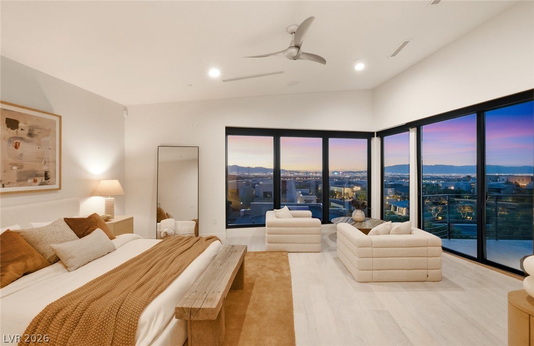 2208 Overlook Canyon Lane, Henderson, NV 89052 Floor-to-ceiling windows offer an unmatched panoramic view from this spacious primary bedroom retreat.