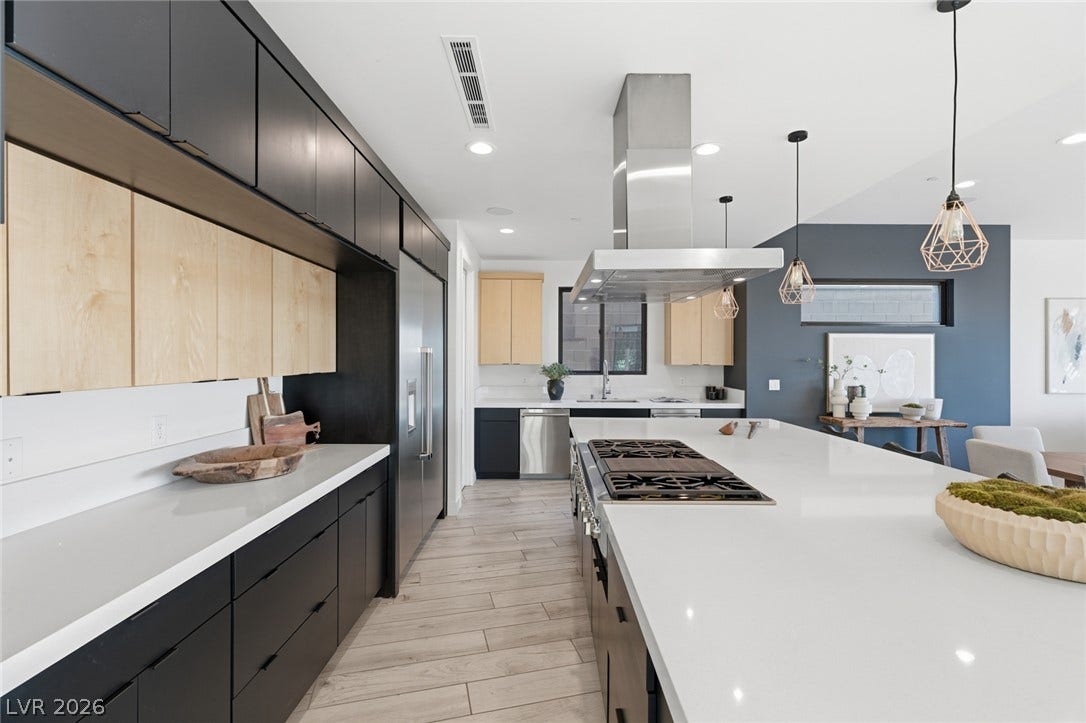 2208 Overlook Canyon Lane, Henderson, NV 89052 A contemporary culinary space with a large kitchen island, sleek cabinetry, and integrated appliances.