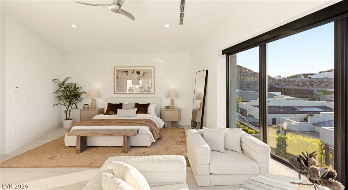 2208 Overlook Canyon Lane, Henderson, NV 89052 A spacious bedroom retreat features high ceilings and panoramic views of the surrounding hillsides.