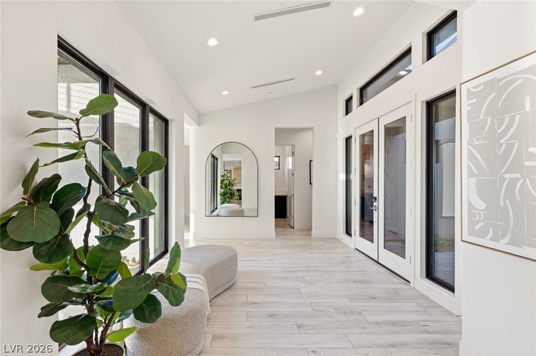 2208 Overlook Canyon Lane, Henderson, NV 89052 A well-lit corridor welcomes you with wide-plank flooring and soaring windows.