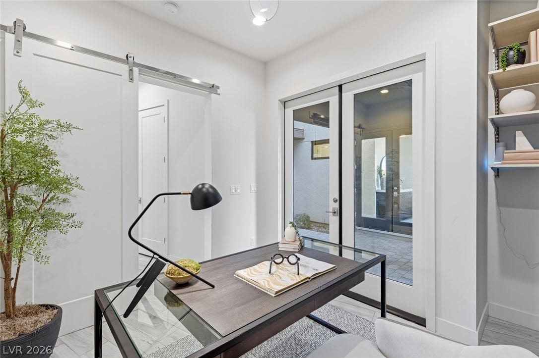 2208 Overlook Canyon Lane, Henderson, NV 89052 A well-lit home office features modern barn doors and glass entry to a private courtyard.