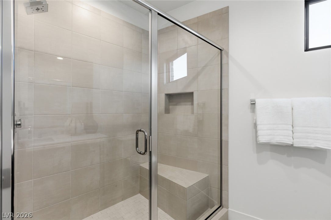 2208 Overlook Canyon Lane, Henderson, NV 89052 A frameless glass shower enclosure creates an open, spa-like atmosphere in this well-appointed bathroom.