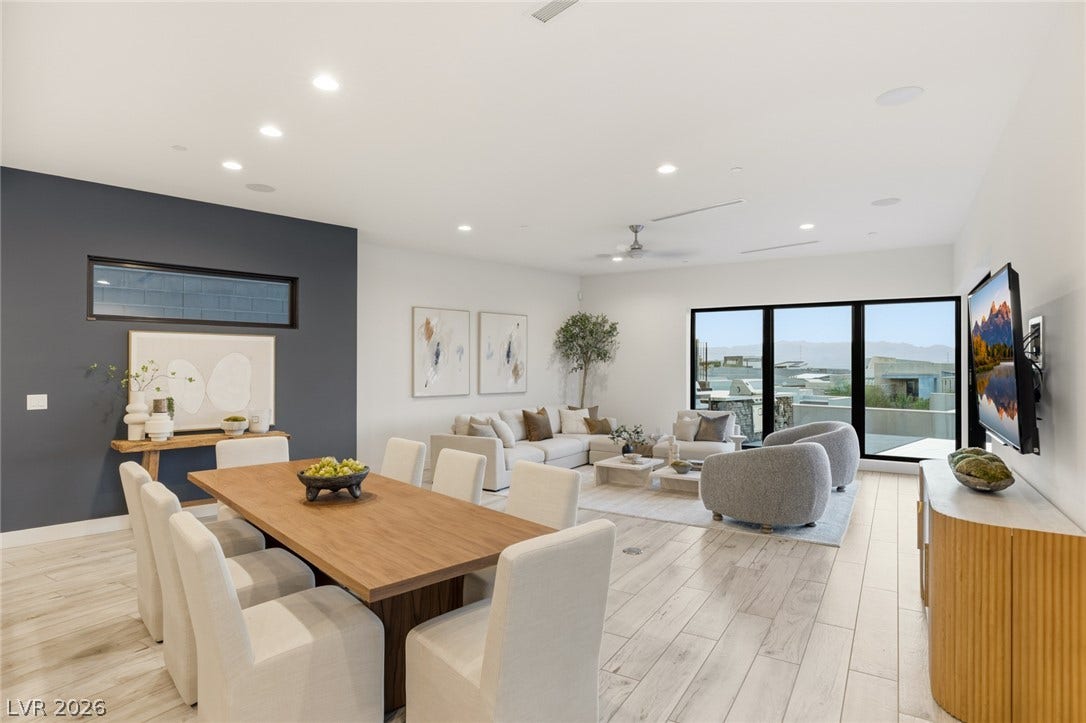 2208 Overlook Canyon Lane, Henderson, NV 89052 Natural light pours into this open-concept living and dining area, featuring sleek modern finishes and panoramic views.