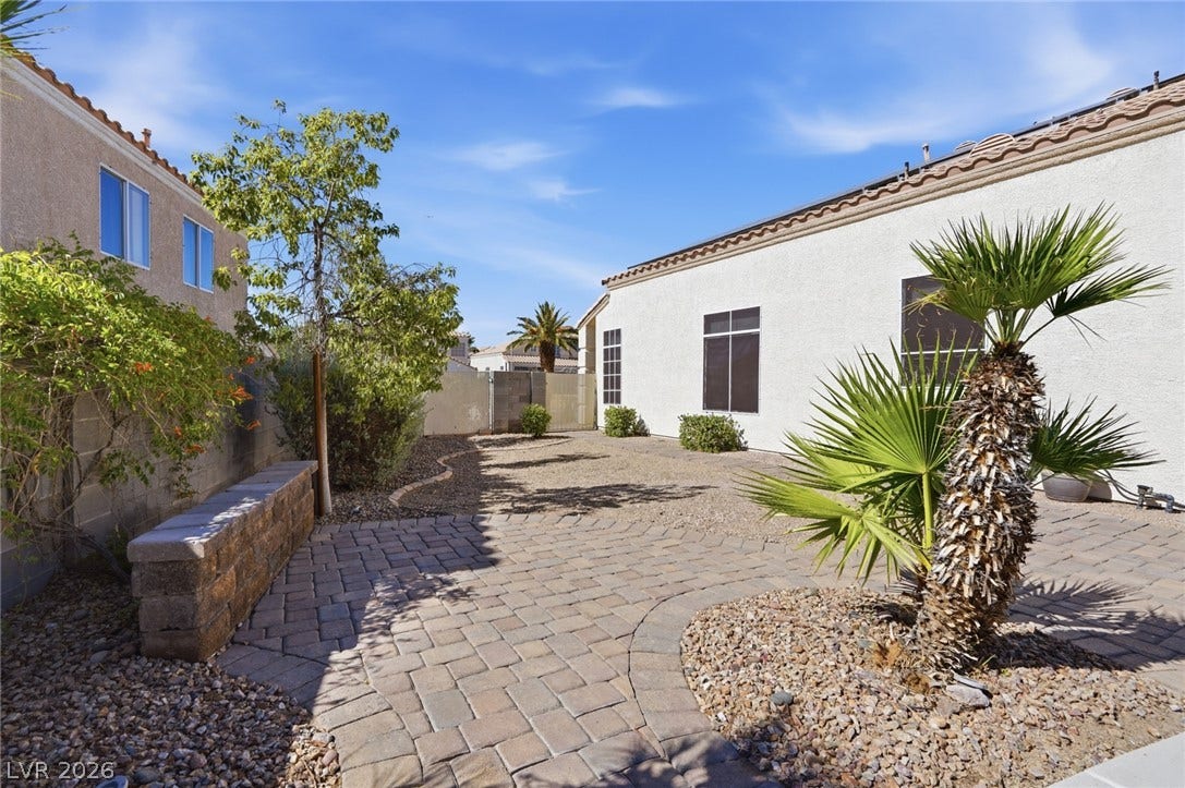 206 Oleander Place, Henderson, NV 89015 An inviting paver patio leads to a serene outdoor space, perfect for relaxation or entertaining.