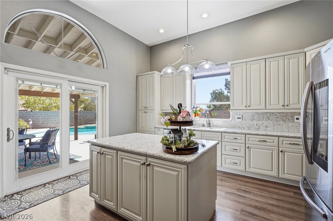206 Oleander Place, Henderson, NV 89015 A well-appointed kitchen offering a central island, granite counters, and seamless outdoor access.