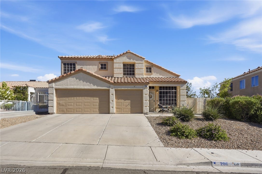 206 Oleander Place, Henderson, NV 89015 A well-maintained stucco facade with a two-car garage and terracotta roof tiles offers appealing curb appeal.