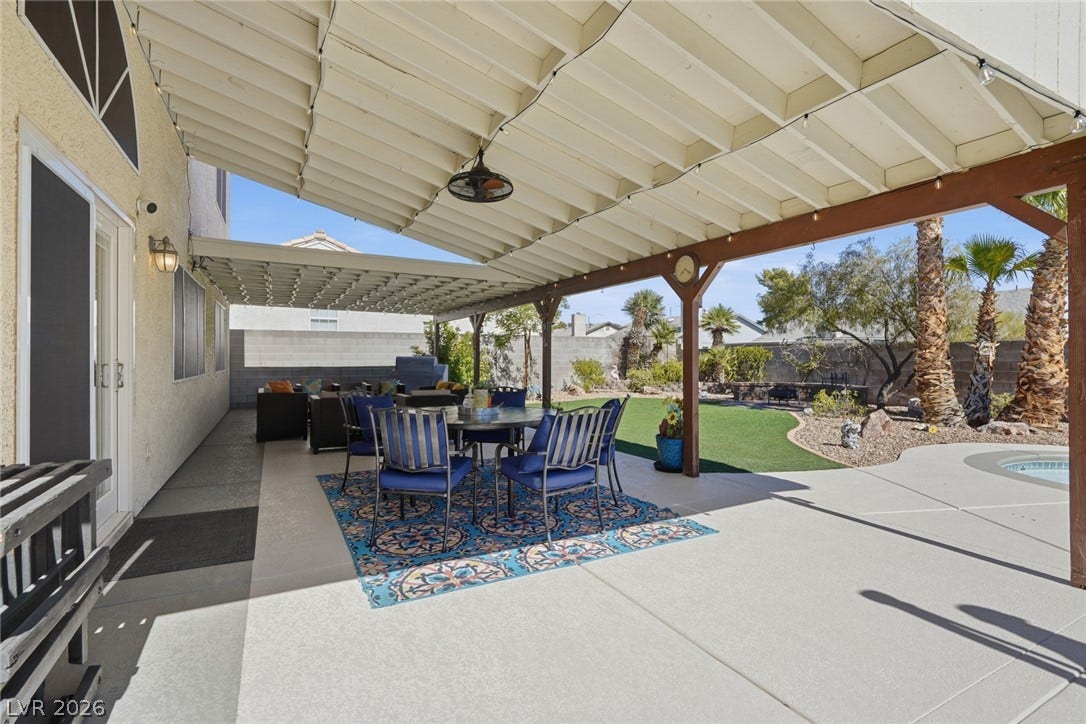 206 Oleander Place, Henderson, NV 89015 A spacious covered patio invites outdoor dining and relaxation overlooking a verdant lawn.