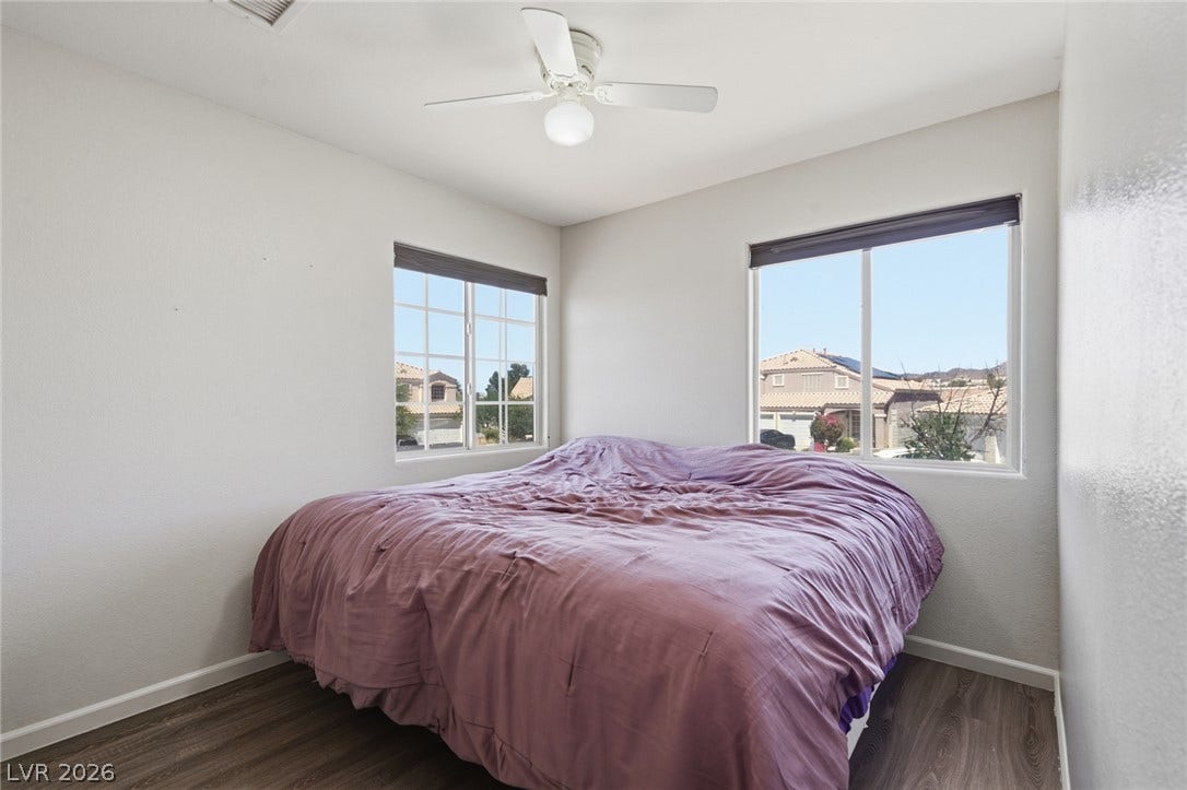 206 Oleander Place, Henderson, NV 89015 A well-lit bedroom offering neighborhood views through its twin windows.