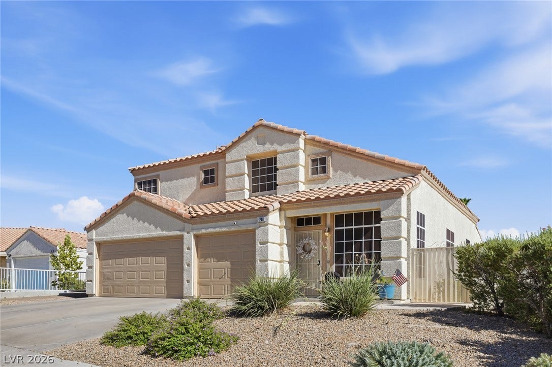 206 Oleander Place, Henderson, NV 89015 A well-maintained stucco home with a tile roof and desert landscaping offers inviting curb appeal.