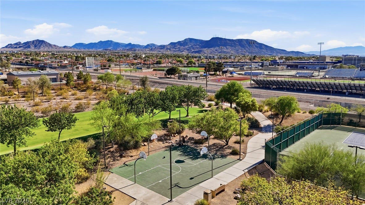 206 Oleander Place, Henderson, NV 89015 An aerial perspective reveals a vibrant community park with mountain views, recreational courts, and green spaces.