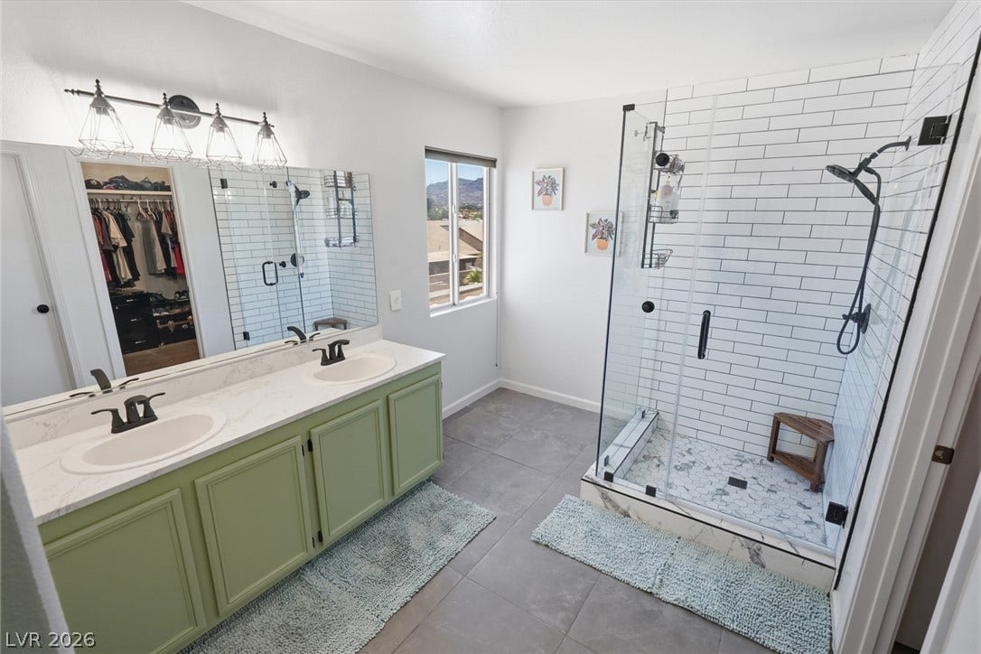 206 Oleander Place, Henderson, NV 89015 A well-appointed primary bathroom featuring a double vanity and a spacious glass-enclosed shower.
