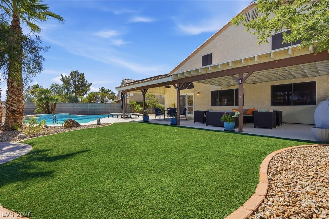 206 Oleander Place, Henderson, NV 89015 A private backyard oasis features a shimmering pool, expansive patio, and manicured lawn for endless enjoyment.