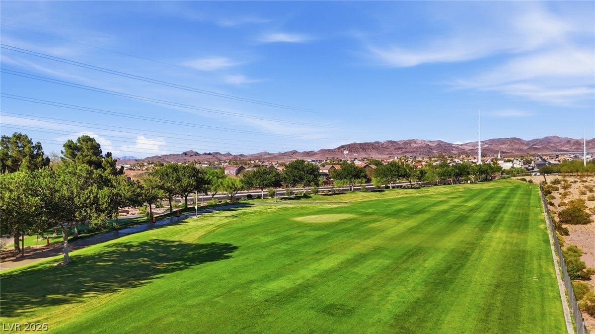 206 Oleander Place, Henderson, NV 89015 A well-maintained golf course with lush green fairways stretches towards the desert hills.