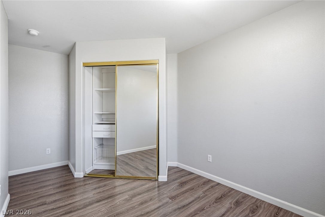 206 Oleander Place, Henderson, NV 89015 A well-organized bedroom with ample storage and reflective closet doors.