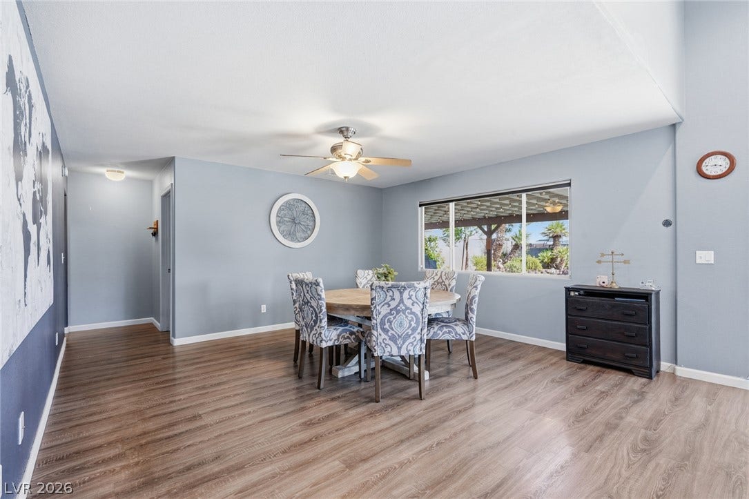 206 Oleander Place, Henderson, NV 89015 Hardwood floors and a bright picture window define this inviting dining area, perfect for gatherings.