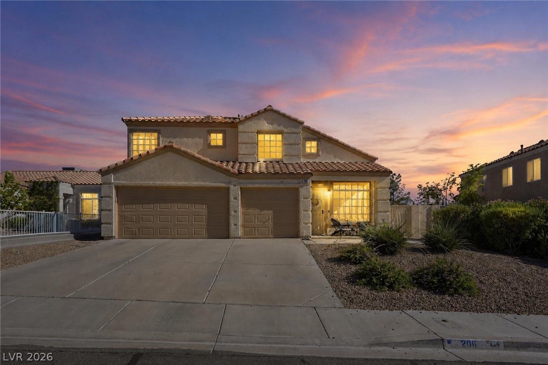 206 Oleander Place, Henderson, NV 89015 Dramatic sunset hues enhance this charming stucco residence with a practical attached garage and well-maintained driveway.